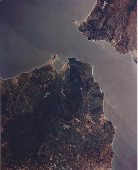 Vertical view of Strait of Gibraltar. Spain to lower left. Morocco to upper right. Note current flow in strait and along coast. The advantages of Gibraltar's harbor are plain to see. (sts059-l19-837)