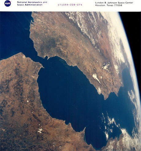 Our view from 120 miles up as we soar over Gibraltar, Spain, and Morocco. Snow caps the Atlas and Sierra Nevada ranges in Africa and Europe. (NASA sts059-238-074)