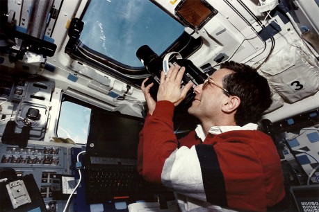 Jay Apt shoots one of our science targets through Endeavour's overhead windows. Mounted in the adjacent window was a large-format Linhof camera, taking a strip of overlapping photos to map each target. (NASA sts059-46-025)